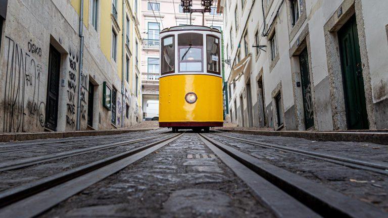 Yellow tram in an old alley in Lisbon, Portugal