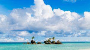 Willie's Rock against the backdrop of the white beach on Boracay Island, Philippines
